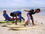 Teach children surfing in South Africa