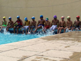 Teach children swimming in India