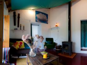 Living-room at L�d�o Cottage, with the wild garlic purple flowers from the farm's meadow.
