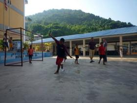 Play sports with the local children