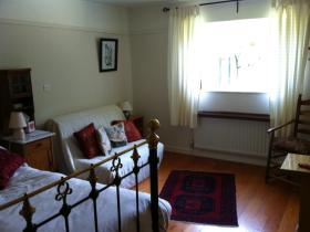 Room 1 B&B King-sized brass bed and futon.