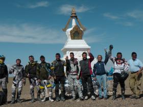 Motorcyclists at sacred stupa in Gobi