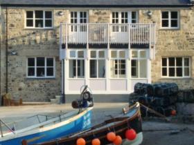 Newly built Island View Holiday Apartments using stonework from original fisherman's cellar