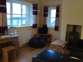 Living area of Fisherman's Loft incuding log burner