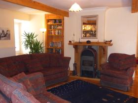Cosy lounge with bar, wood-stove, books & games, big-screen home cinema and free internet access