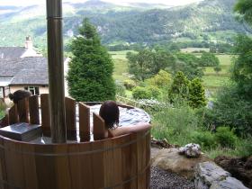 Relax in the log-fired hot tub in the wood - available for exclusive use