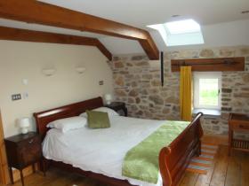 Luxurious light filled master bedroom in The Cow Shed