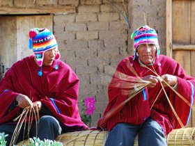 Men weaving reed boats on Lake Titicaca