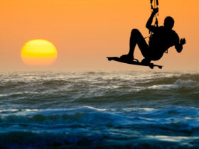 Kite surfing at sunset