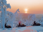 Snowmobiles at sunset