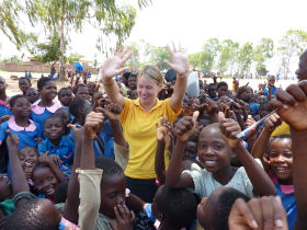 Volunteer with children in Zambia