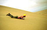 Dune sledding on Africa overland adventure