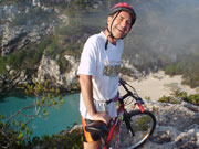 Cyclist ontop of a cliff, Menorca. Photo by Audax Hotels
