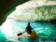 Kayaking through caves in Menorca. Photo by Audax Hotels