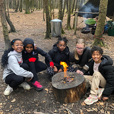 The children learning bushcraft skills together
