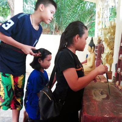 children looking at a shrine