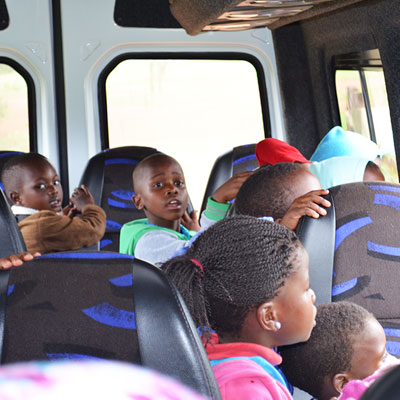 Children looking from bus window