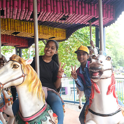 Kids ride a merry go round at Nicco Amusement park, India