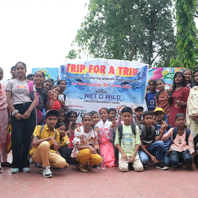 Kids pose infront of a trip for a trip sign at Nicco amusement park, India