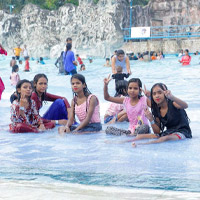 A group of children playing in the Nicco Water Park pools